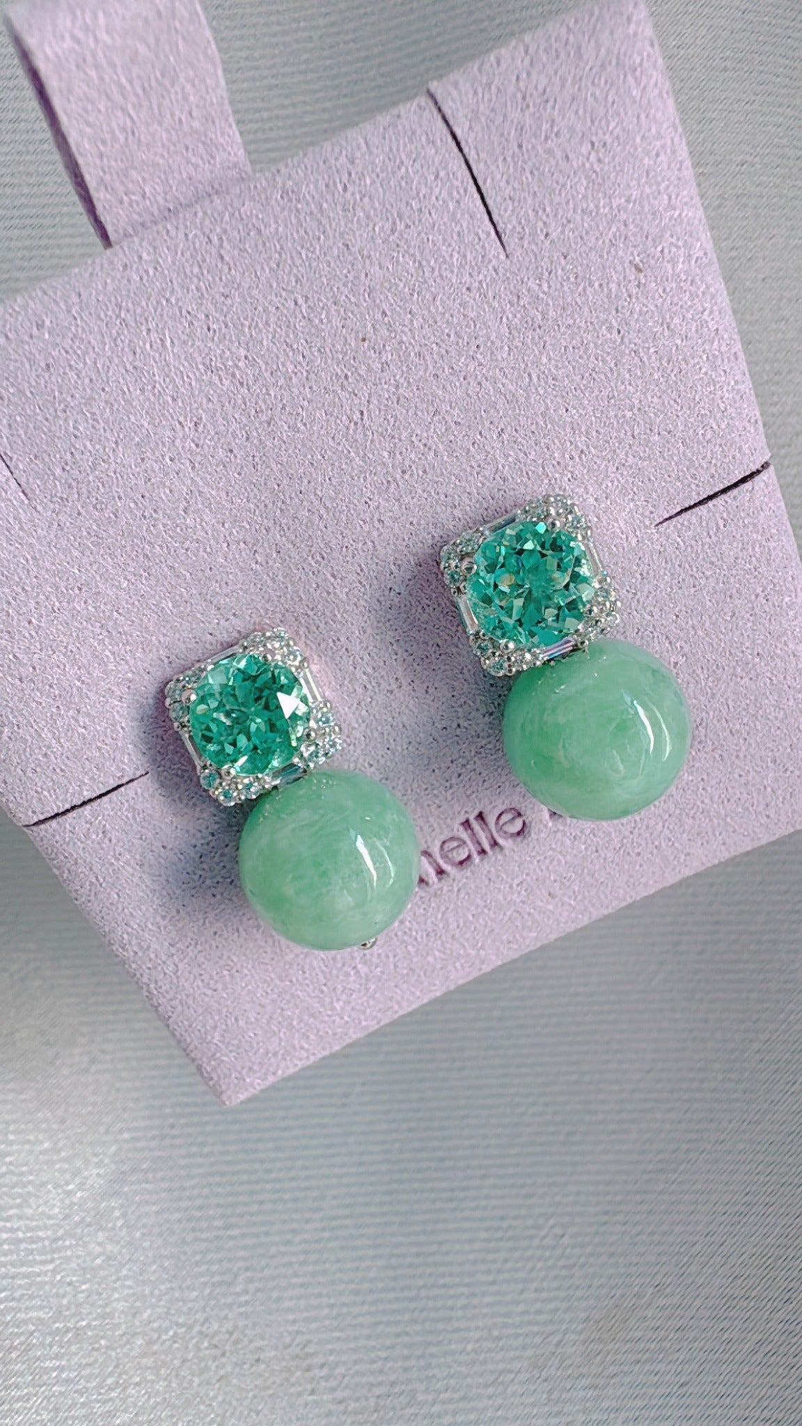 Poised Elegance earrings with mint lab sapphires and light apple-green jadeite, reference angle 3