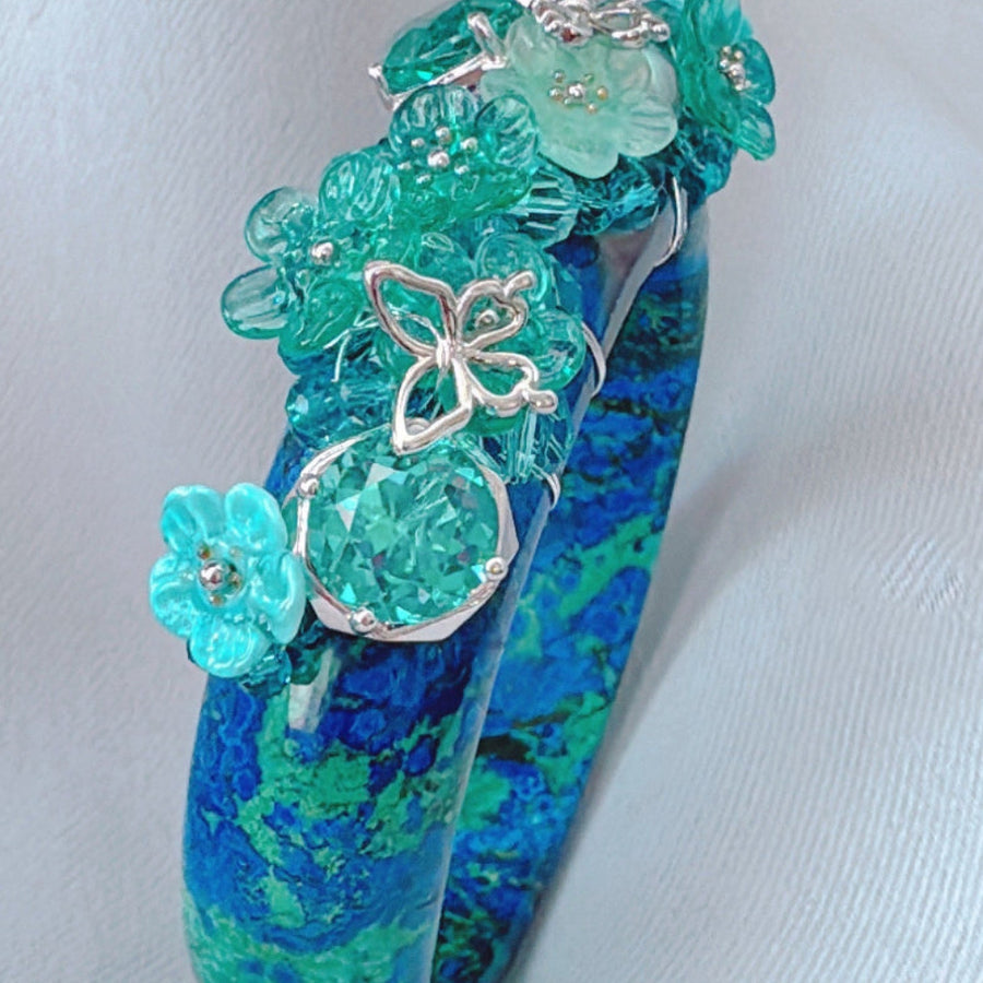 Art Bangle with blue and green floral design on a white background